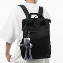 Urban Commuter: Stylish Black Backpack with Plush Charm