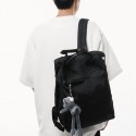 Urban Commuter: Stylish Black Backpack with Plush Charm